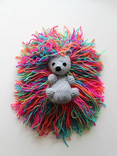 crocheted toys and yarns are arranged on the table, including a stuffed animal