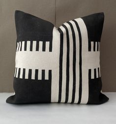 a black and white pillow sitting on top of a table