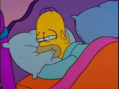 the simpsons is laying in bed with his head on pillows and looking at something off to the side