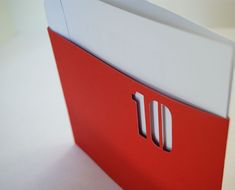 an open red and white folder sitting on top of a table