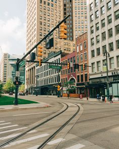 an intersection with traffic lights and buildings in the background