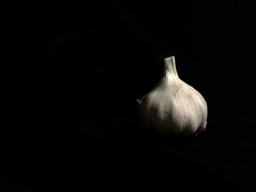 an onion is shown in the dark with its head still on it's side