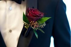 a man in a tuxedo with a boutonniere on his lapel