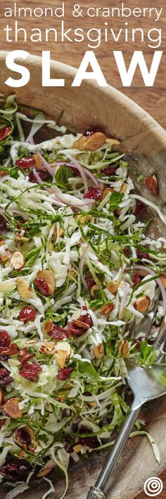 a wooden bowl filled with salad on top of a table