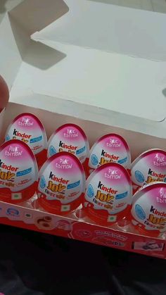 a person is holding a dozen eggs in a carton