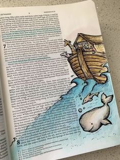 an open book with a drawing of a whale and a man in a boat