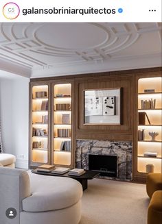 a living room filled with furniture and a fire place in front of a book shelf