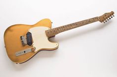 an electric guitar sitting on top of a white table