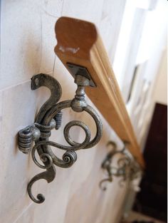 an ornate metal hook on the side of a wall