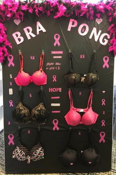 bras and pong bras are displayed on a black board with pink ribbons