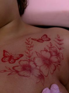 a woman's breast with flowers and butterflies on it