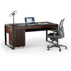 an office desk with a laptop on it and a chair in front of the desk