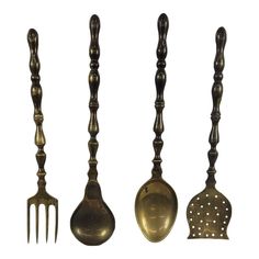 four antique metal utensils lined up next to each other