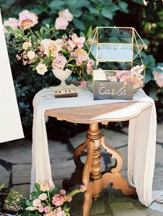 a table with flowers and cards on it