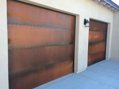 two brown garage doors on the side of a building