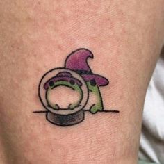 a small tattoo on the leg of a person with a hat and pipe in it