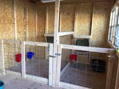 the inside of a house that is being built with wooden walls and metal cages