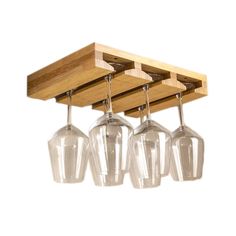 four wine glasses hanging from a wooden rack