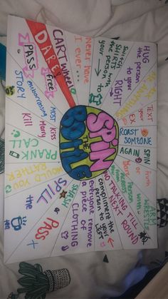 a poster with words written in different languages on the front and back of it, sitting on top of a bed