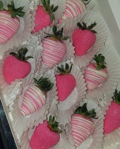 a box filled with lots of pink and white strawberries on top of each other