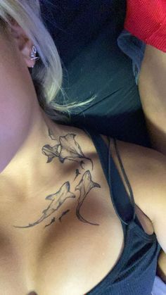 a woman with a bird tattoo on her chest