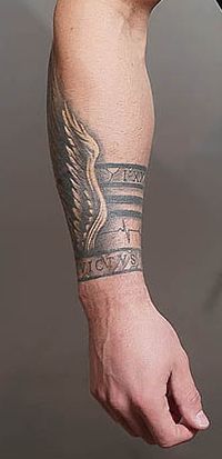 a man's arm with an eagle tattoo on it and the words love is written across his arm