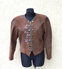 "Brown Trachten Jacket Vintage Women's Double Breasted Bavarian Octoberfest Leather Jacket Embroidered Hunting Riding Lamb Leather coat.  This nice jacket is in good condition with one stane (look picture). Nicely lined.  Brand: LS Sound Material - 100% real lamb  leather Lining - 100% polyester Label size: 40 Length (back): 21\"/ 54 cm Bust : 20\"/ 51 cm Shoulder: 17\"/43 cm Sleeve: 23\"/59 cm Please check measurements to insure a proper fit. Remember to allow yourself some extra room for movem Folk Style Brown Outerwear For Fall, Folk Style Fitted Fall Outerwear, Fitted Folk Style Outerwear For Fall, Fitted Folk Outerwear For Fall, Fitted Folk Style Fall Outerwear, Traditional Fall Outerwear With Buttons, Traditional Outerwear With Button Closure For Fall, Embroidered Costume Outerwear For Fall, Traditional Fall Costume Outerwear