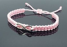 a pink and black bracelet with an silver clasp