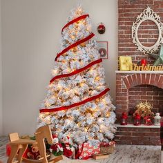 a decorated christmas tree in front of a fireplace