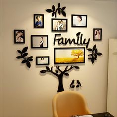 a family tree with pictures on the wall above it and a table in front of it