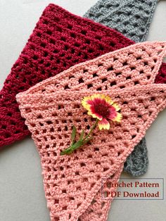 three crocheted napkins with a single flower on one side and the other half