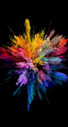 colored powder is flying in the air on a black background