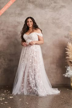 a woman in a white wedding dress posing for the camera