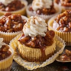 cupcakes topped with caramel and whipped cream on a metal tray next to other dessert items