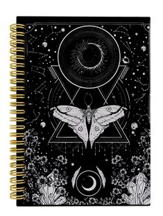 a spiral notebook with an image of a moth on the cover and stars in the background