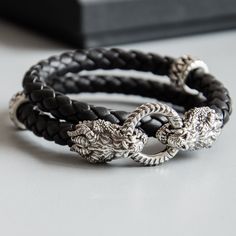 New collection of Dragon Bracelets! Sterling Silver Dragon Bracelet Overview video: https://youtu.be/dVBBuGABEzY The bracelet made using silver and braided nappa leather of high quality. The bracelet has high detalization, it is possible to see every element of dragon head. The bracelet combines the unique image and strength of the totem jewelry and looks like a modern and stylish accessory that would become your faithful companion and fit seamlessly into any style, everyday or business. Silver Bracelet Man, Dragon Bracelet, Bracelet Christmas, Dragon Jewelry, Dragon Head, Silver Dragon, Black Bracelets, Unisex Jewelry, Nappa Leather