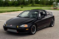 a black sports car parked in a parking lot