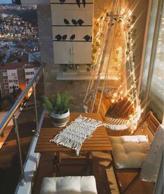 the balcony is decorated with string lights and wooden furniture, while birds are perched on the ladder