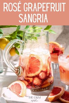 rose grapefruit sangria in a pitcher with sliced oranges