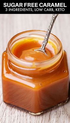 a jar filled with caramel sauce on top of a wooden table