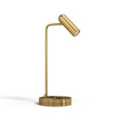 a gold desk lamp on a white background