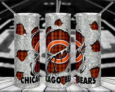 three chicago bears tumblers sitting on top of a wooden table