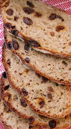 slices of bread with raisins on a red and white checkered cloth