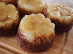 some kind of dessert that is on a wooden board with icing and caramel