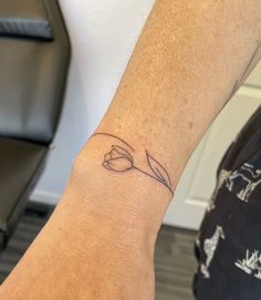 a person with a small tattoo on their arm