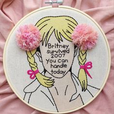 two pink pom - poms are on top of a embroidery hoop with the words,'birthday survived you can handle today '