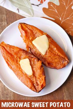 two pieces of bread on a white plate with butter in the middle and an orange napkin next to it