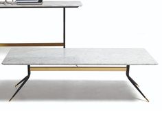 two tables with marble top and black metal legs, one is white and the other is gold