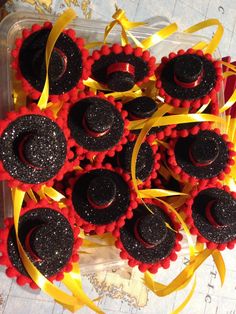 there are many cupcakes that have been decorated with red and black icing