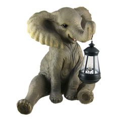 an elephant sitting next to a lamp on a white background